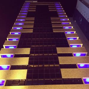 a tall building with blue and purple lights on it at Magnífico Flat no melhor de Manaíra - Apart Hotel in João Pessoa