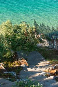 a fence on the side of a beach near the water at Villa Victoria by La Scala Beach in Limenas