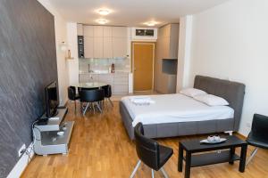 een kleine kamer met een bed en een keuken bij Don Vito in Belgrado