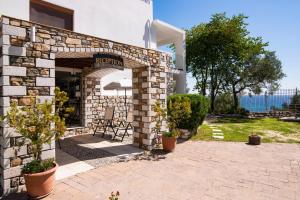 a stone building with a sign that reads reception at Villa Victoria by La Scala Beach in Limenas