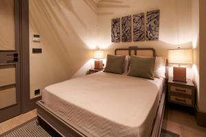a bedroom with a large bed with two lamps at Root Redrock Yalıkavak in Yalıkavak