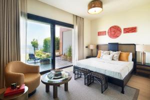 a bedroom with a bed and a living room at Root Redrock Yalıkavak in Yalıkavak