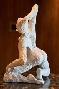 a white sculpture of a person dancing on a table at Root Redrock Yalıkavak in Yalıkavak