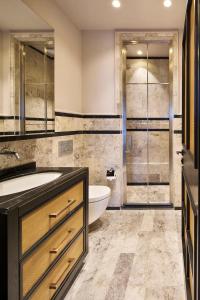 a bathroom with a sink and a tub and a toilet at Root Redrock Yalıkavak in Yalıkavak