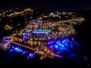 an aerial view of a pool at night at Root Redrock Yalıkavak in Yalıkavak