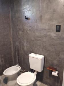 a bathroom with a white toilet and a sink at Hotel Segundo Roma in Villa La Paz +37 photos