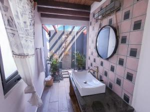 a bathroom with a tub and a mirror at Catalina's Hideaway in Santa Catalina