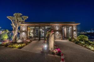 a building with flowers in front of it at night at Root Redrock Yalıkavak in Yalıkavak