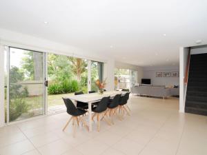 a dining room with a table and chairs at Acacia on Orion by Jervis Bay Rentals in Vincentia