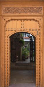 a wooden archway with a building in the background at La Sultana Apartamentos in Córdoba