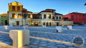 a cobblestone street with buildings in a city at Foleza - Bed and breakfast in Vlorë