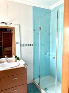 a bathroom with a glass shower and a sink at Suite like Sweet-Refugio tranquilo in Torres Vedras +20 photos
