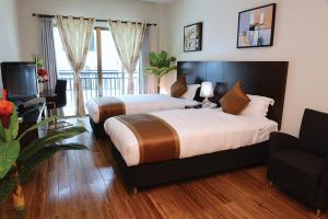Uma cama ou camas num quarto em Timor Plaza Hotel & Apartments