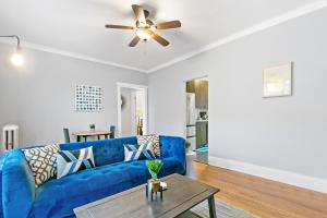 a living room with a blue couch and a table at 1BR Tranquil & Airy Apartment in Lincoln Square - Campbell rep in Chicago