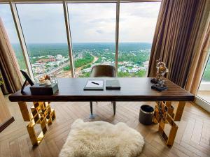 a desk in a room with a large window at Diamond Stars Ben Tre Hotel in Ben Tre