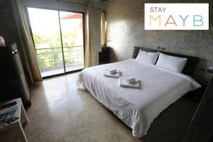 Postel nebo postele na pokoji v ubytování STAY MAYB Chiang Mai