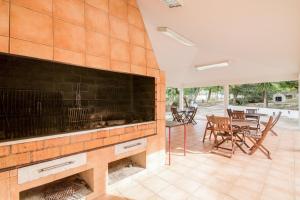 a large fireplace in a living room with a table and chairs at Bosque São José Af in Albufeira