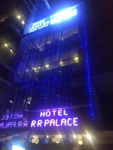 a hotel entrance with blue lights and a sign at HOTEL R R PALACE in Gorakhpur
