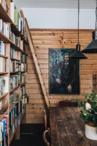 a hallway with a painting of a man in a library at The Main House @ Poets Lodge in Daylesford