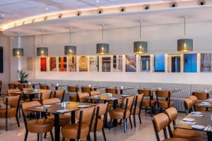 a dining room with tables and chairs at Mayfair Gardens in Paphos