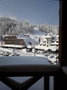 a view of a ski resort with snow covered buildings at Apartment 216 NiM Vučko in Jahorina