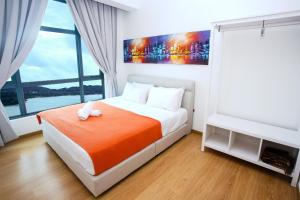 a bedroom with a bed and a large window at NASA Family Suite at Imperium Residence in Kuantan