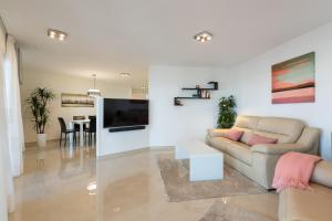 a living room with a couch and a table at Luxury Terrace Ocean view-P67B By CanariasGetaway in Playa del Aguila