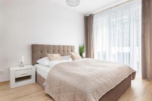 Posteľ alebo postele v izbe v ubytovaní Kasprowicza 20 Uzdrowisko by Jantar Apartamenty Kołobrzeg