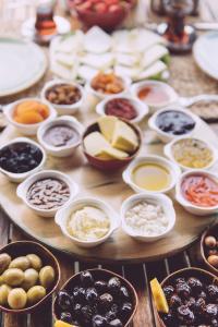a wooden table with different types of food in bowls at Park Mandalin Hotel - Adult only in Ağva