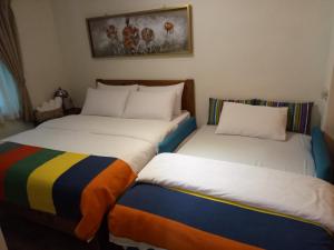 Katil atau katil-katil dalam bilik di Jilufugan B&B
