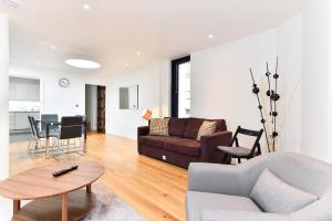 a living room with a couch and a table at London Bridge Central Apartments in London