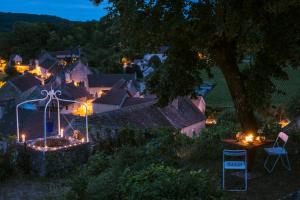 a view of a village at night with lights at Le Domaine des Carriers - Gites in Chevroches