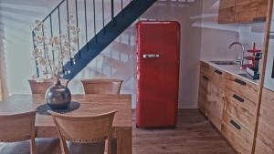 an old red refrigerator in a kitchen with a table at Hotel Els Caçadors de Ribes in Ribes de Freser