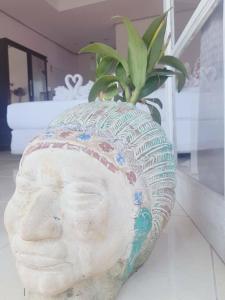 a statue of a head with a plant in it at Prathana Garden Beach Resort in Hua Hin