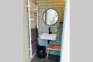 a bathroom with a sink and a mirror at De slaaploods in Kerkrade