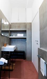ein Badezimmer mit einem Waschbecken, einem Spiegel und einer Theke in der Unterkunft Florestine Napoli in Neapel