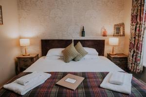 a bedroom with a bed with a book on it at Inn in the Park in Bournemouth