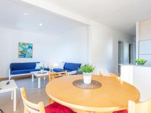 a living room with a table and a blue couch at Apartment Santa Lucia by Interhome in Montjoys