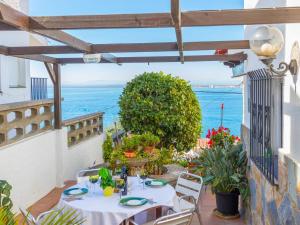 a table on a balcony with a view of the ocean at Holiday Home Mila i Fontanals by Interhome in Roses