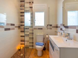 a bathroom with a toilet and a sink and a shower at Holiday Home Mila i Fontanals by Interhome in Roses