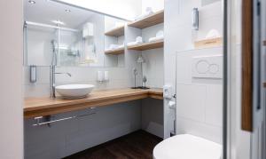 a bathroom with a sink and a toilet at Hotel Landhaus in Münster +57 photos