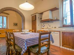 a kitchen with a table and chairs in a room at Villa di Vinci by Interhome in Cerreto Guidi