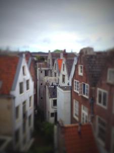a view of a group of buildings with roofs at Cosy city loft view RIJKSMUSEUM in Amsterdam