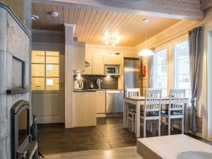 a kitchen and dining room with a table and chairs at Holiday Home Leimu a by Interhome in Vuokatti