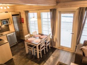 a kitchen and dining room with a table and chairs at Holiday Home Leimu a by Interhome in Vuokatti +17 photos