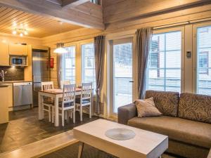 a living room with a couch and a table at Holiday Home Leimu a by Interhome in Vuokatti