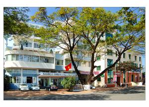 a building with a tree in front of it at Bamboo Green Riverside Hotel in Danang