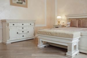 a bedroom with a large bed and a dresser at Apart-hotel Horowitz in Lviv