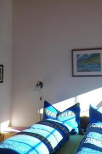 a bedroom with blue and white pillows on a bed at Apartment Morgenstern by Interhome in Sankt Stephan