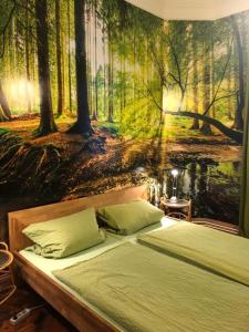 a bedroom with a painting of a forest at Gästezimmer am Hansaplatz in Hamburg